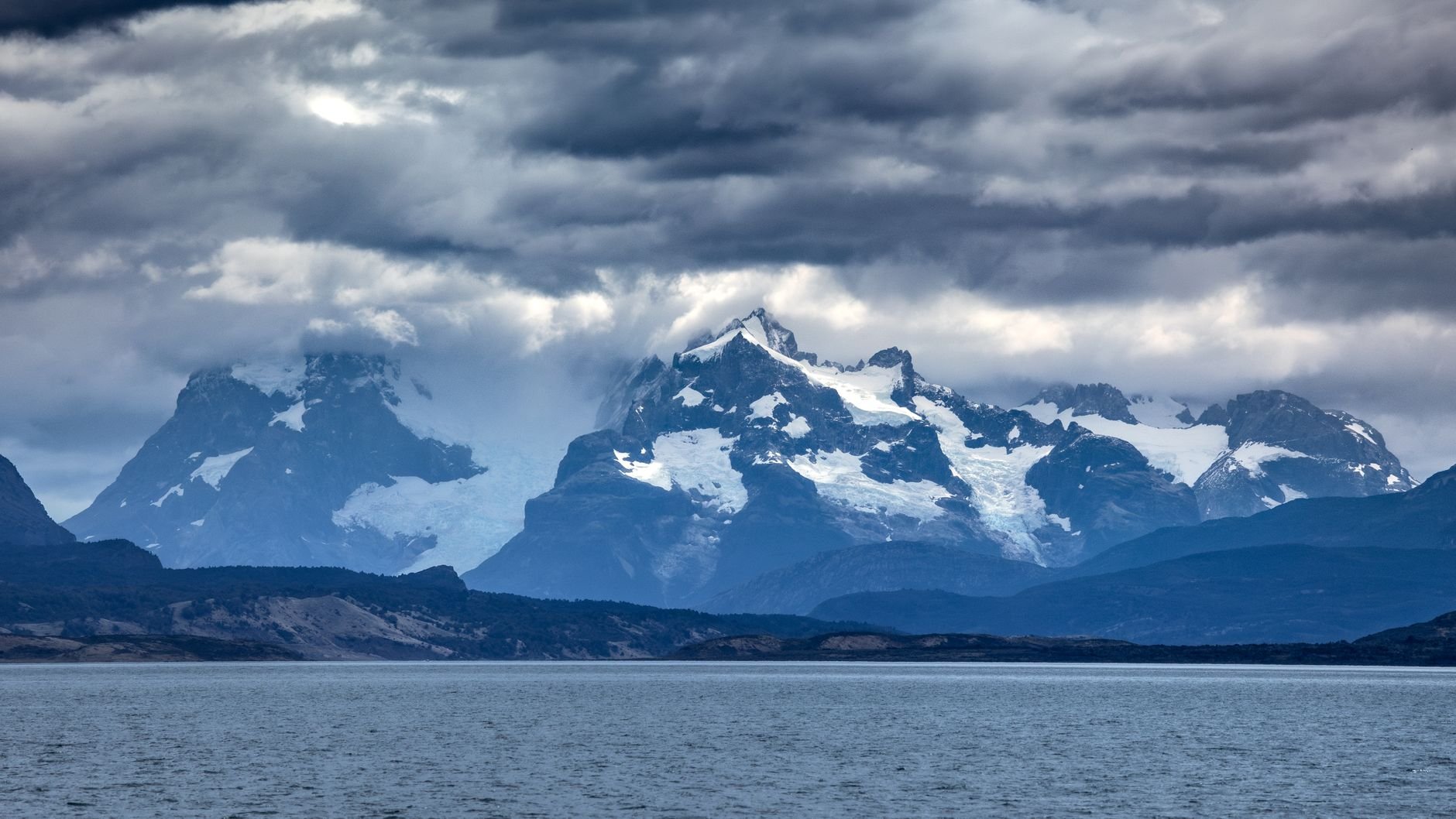 Stunning snow-capped mountains in Patagonia under dramatic clouds